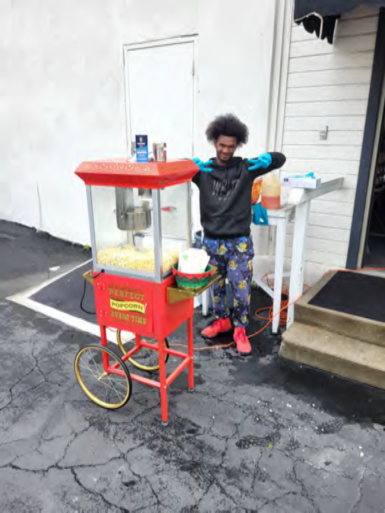 vendor with popcorn machine